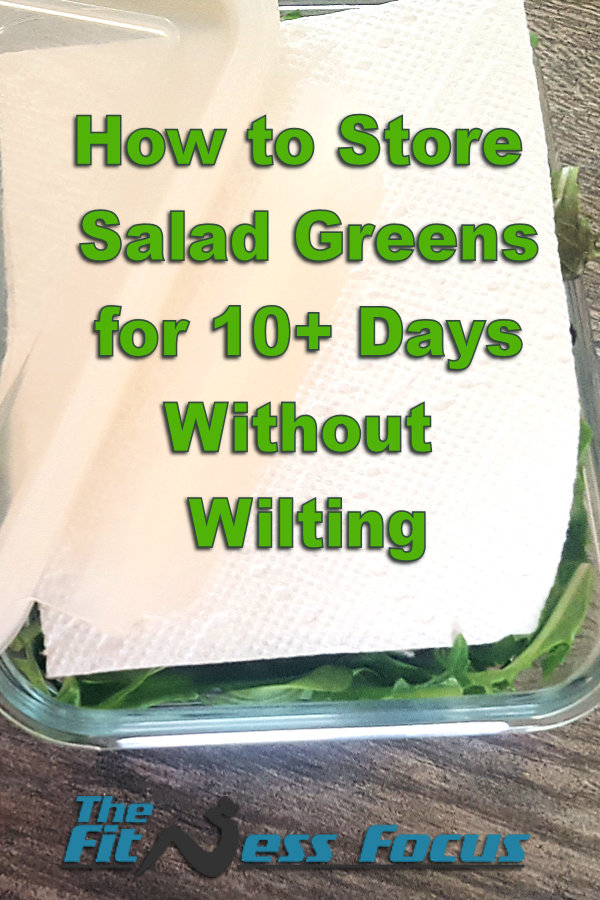 stored salad greens in glass container with paper towel