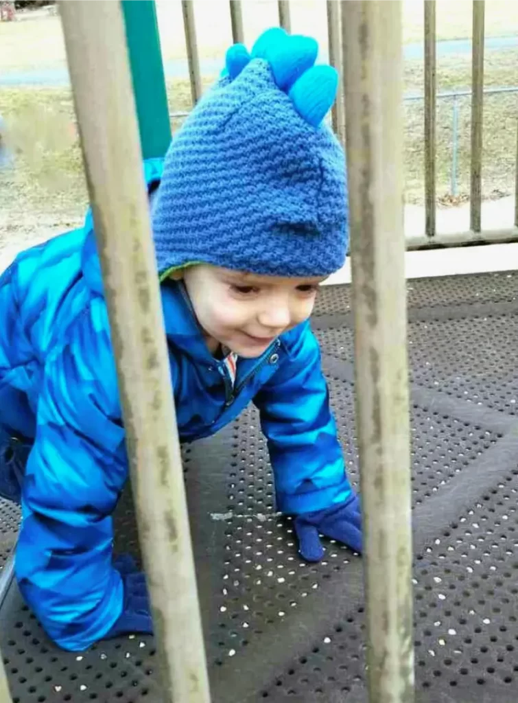 Zachary at age 3 at the playground while mom works out