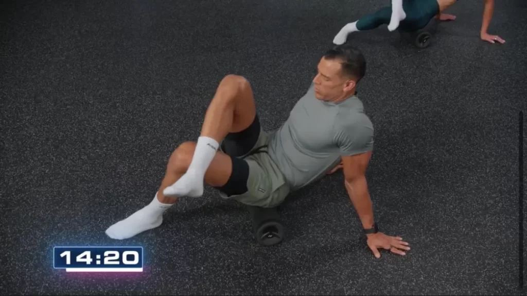 p90x generation next myofascial release workout with waz ashayer doing a leg oam rolling exercise 