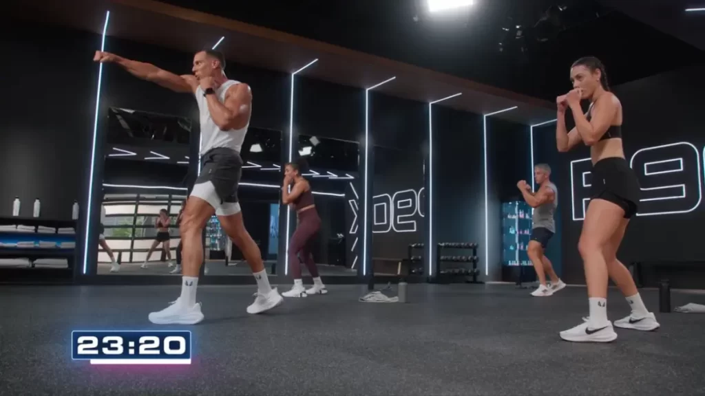 p90x generation next cardio boxing workout with waz ashayer in foreground and cast behind while boxing