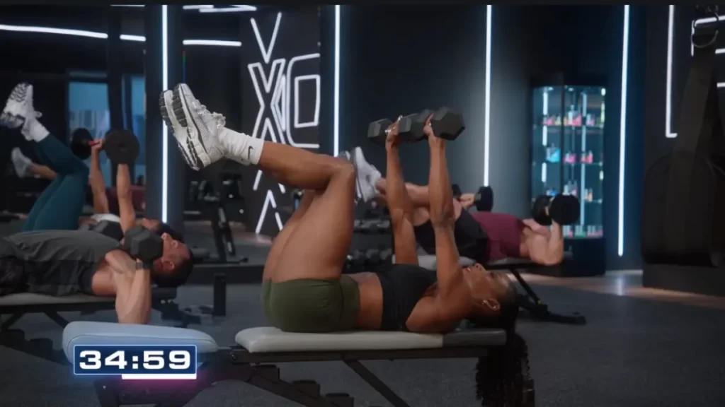 p90x generation next strength workout with cast member doing a dumbbell press with feet up in table top position